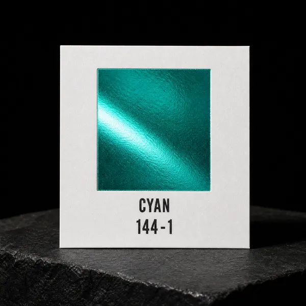 Cyan 144-1 foil chip photographed on slate