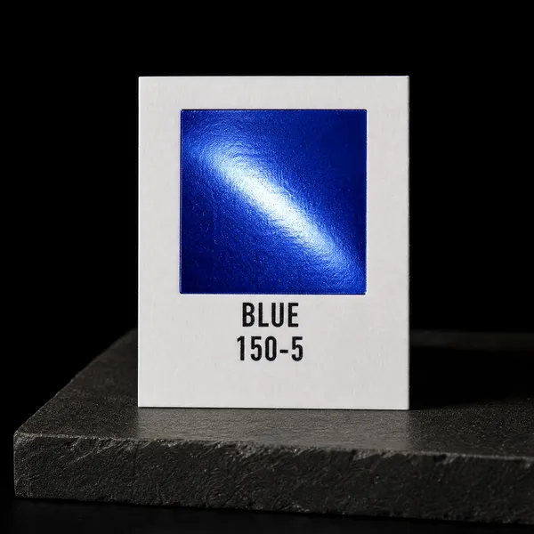 Blue 150-5 foil chip photographed on slate