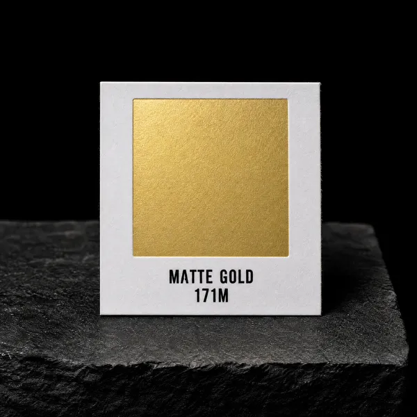 Matte Gold 171M foil chip photographed on slate