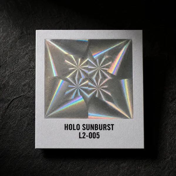 Holo Sunburst L2-005 foil chip photographed on slate