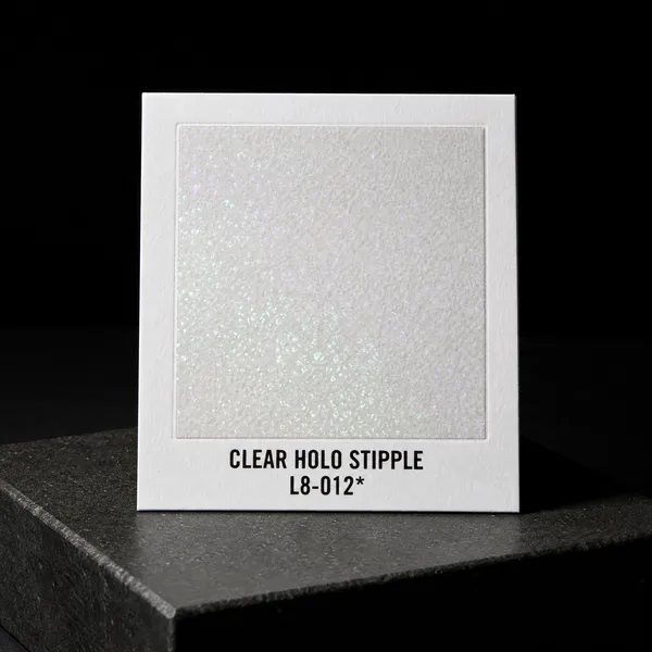 Clear Holo Stipple L8-012 foil chip photographed on slate