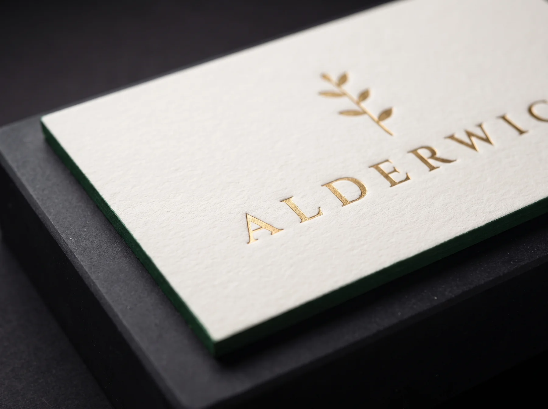 Close-up simulation of the foil sprig pressed into the cotton, with the painted green edge